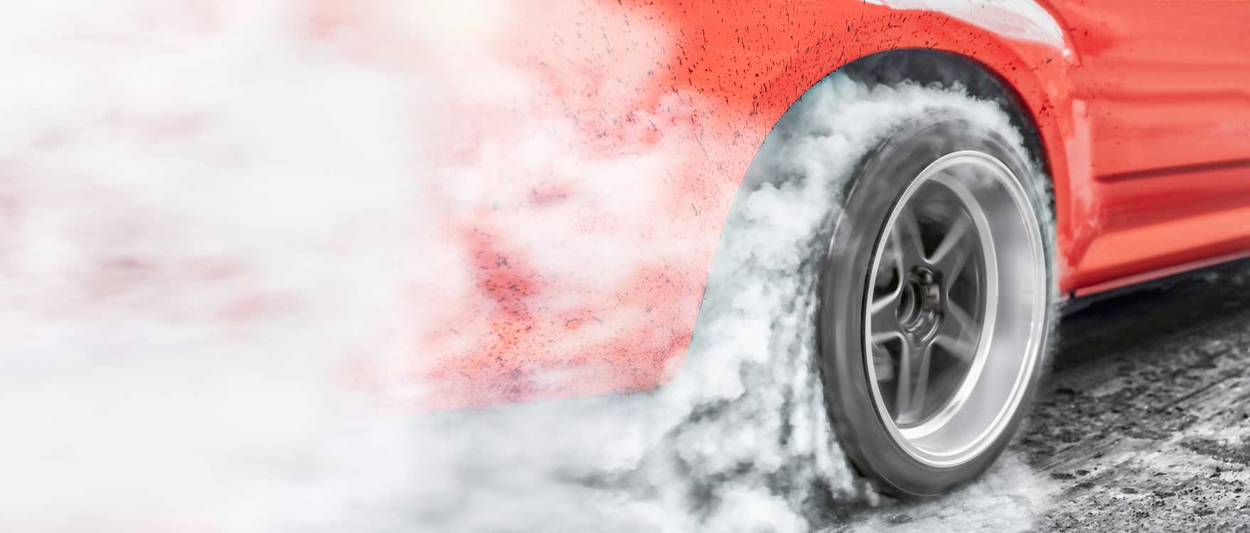 Car tire spinning and creating thick, white smoke